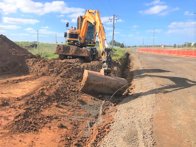 Excavator on flat ground yet tilt hitch used fully.